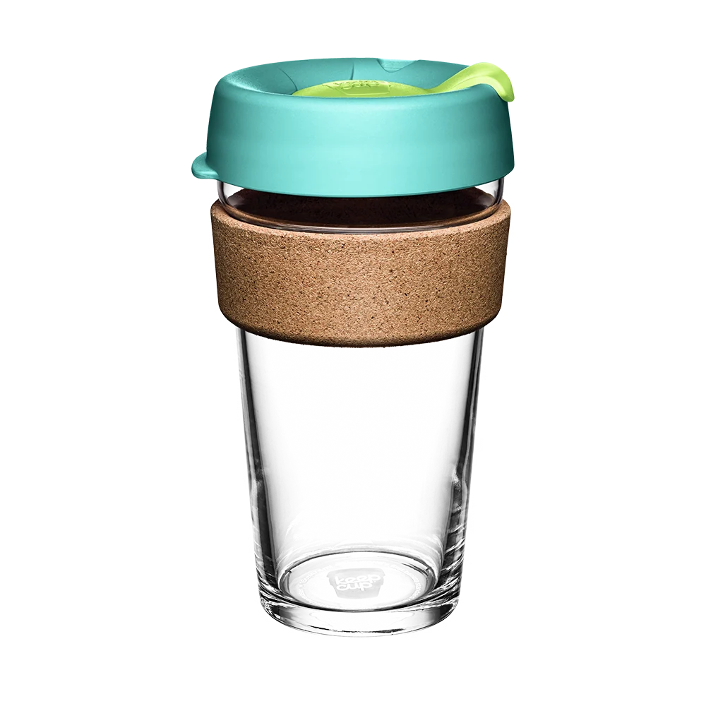 Clear glass reusable cup with a mint lid and cork sleeve on a white background