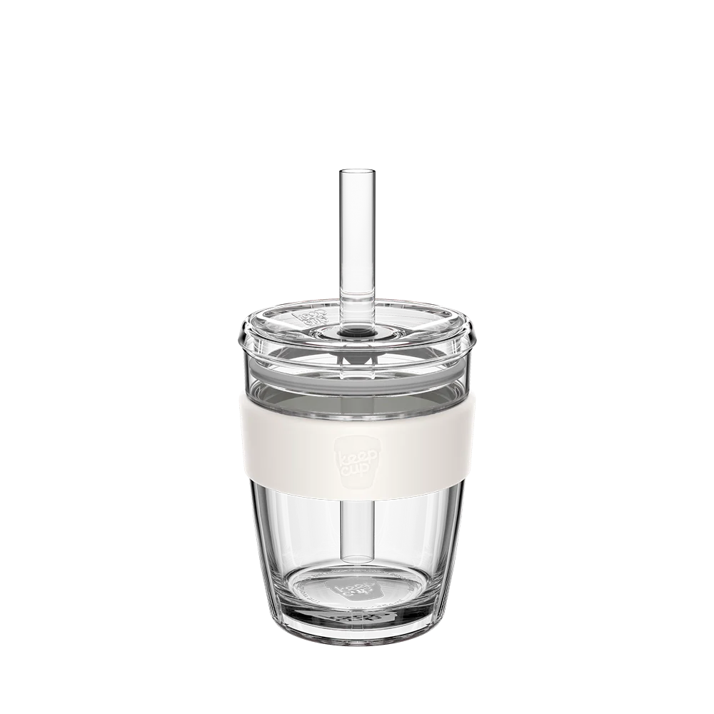 Clear glass 12oz tumbler with a white base and straw on a white background