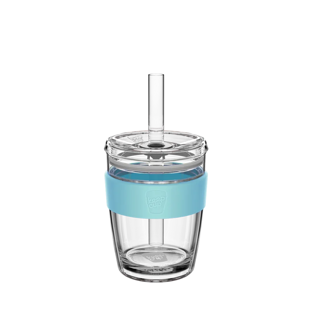 Clear tumbler with a blue band and boba straw on a white background