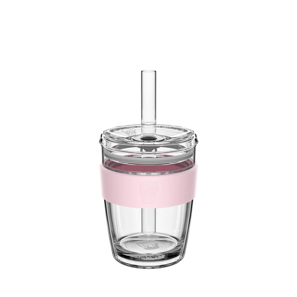 Clear tumbler with pink band and straw on a white background