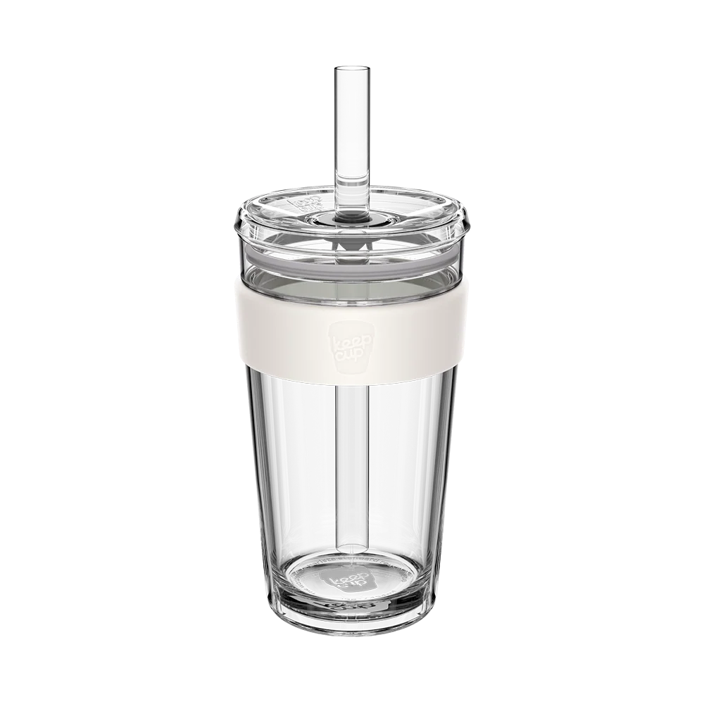 Large glass tumbler with a white band and boba straw on a white background