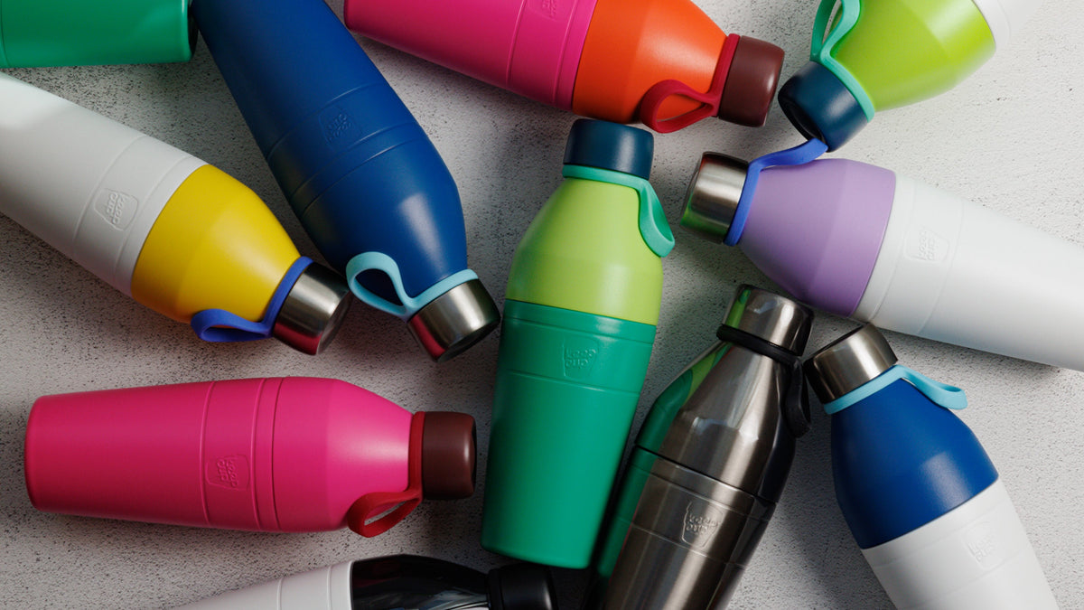 Collection of colourful reusable water bottles in various sizes and materials including stainless steel and plastic in blue, pink, green, yellow and purple