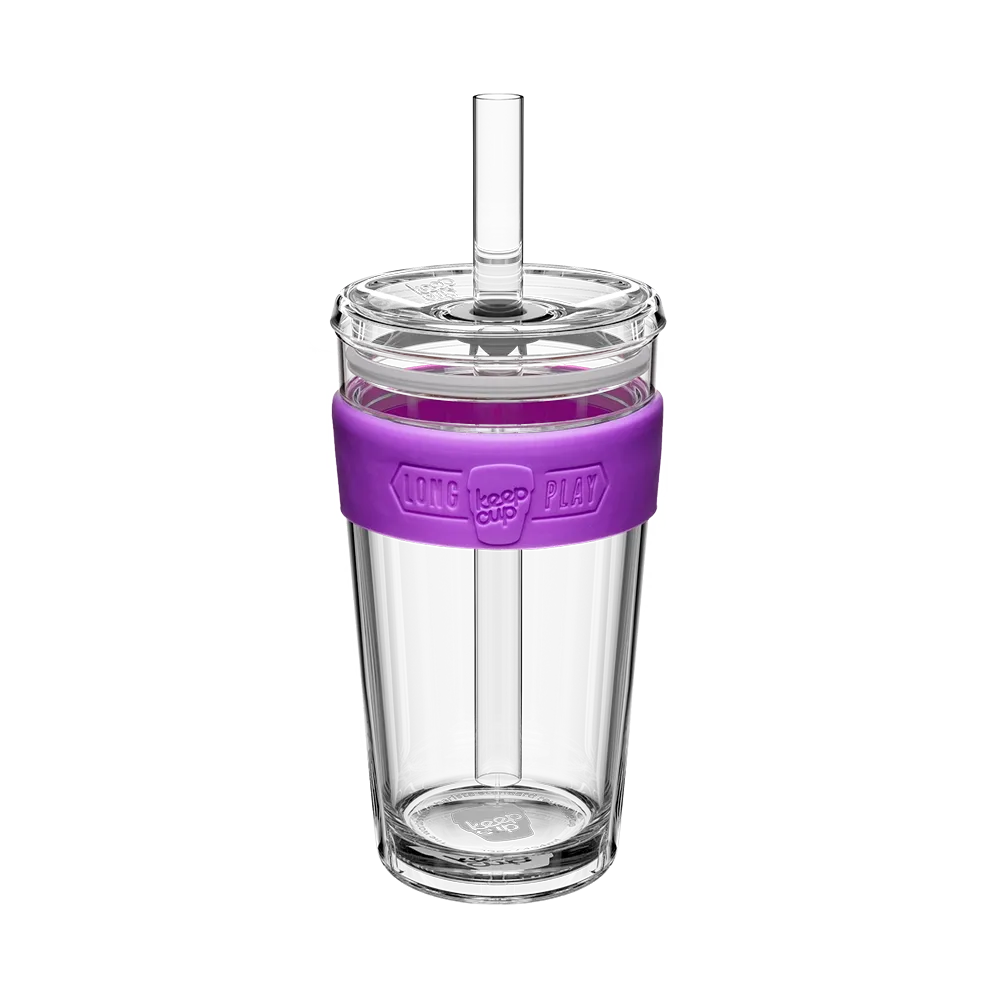 Clear tumbler with a purple sleeve and straw on a white background