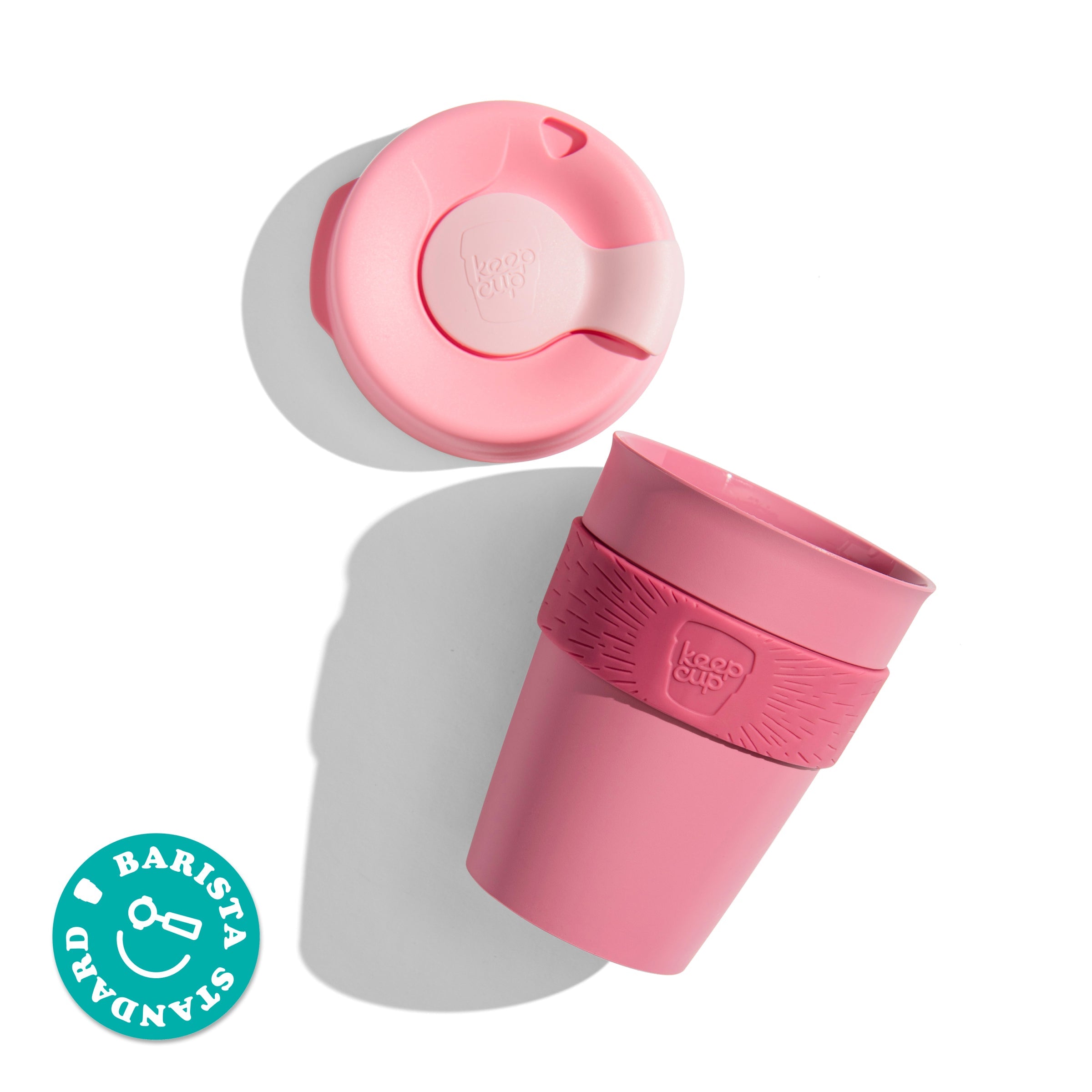 KeepCup Original M 12oz shown from above with the lid separated from the cup body featuring a silicone band, displaying the Barista Standard certification badge.