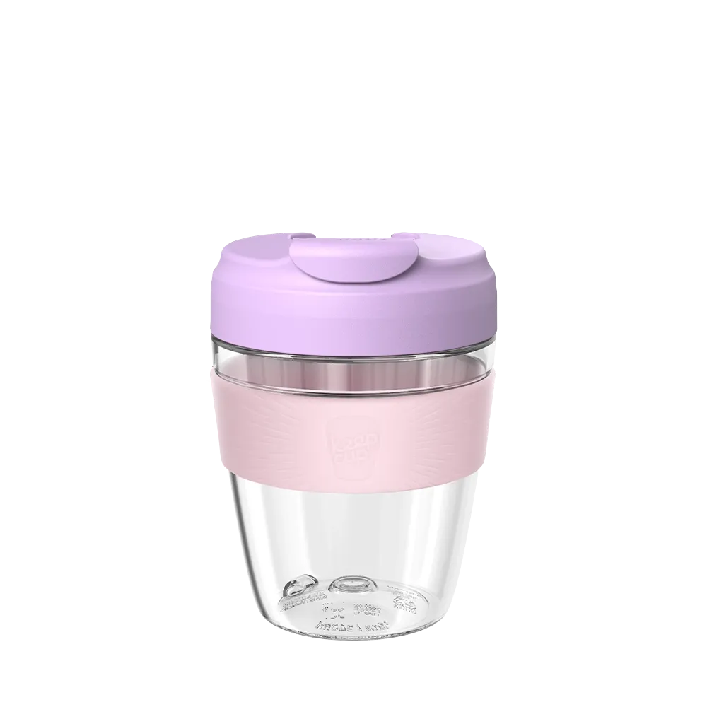 Clear tumbler with pink base and lid on a white background
