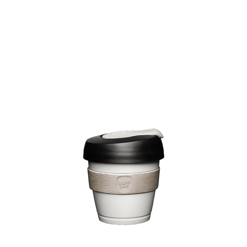 White reusable 4oz coffee cup with black lid and beige base on a white background