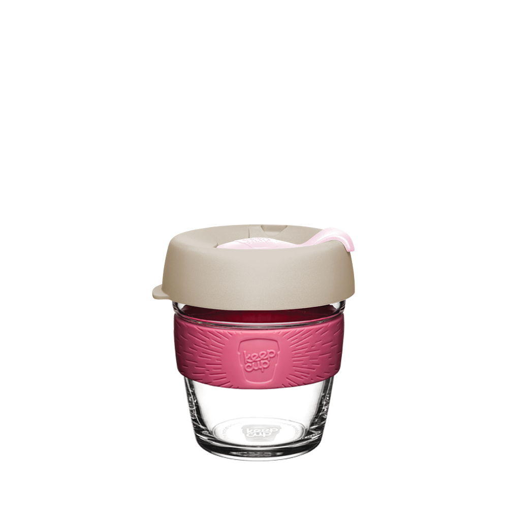 KeepCup Brew XS 6oz in Primrose, featuring a clear glass cup with a guavaband and latte lid with pink plug, shown against a plain white background.