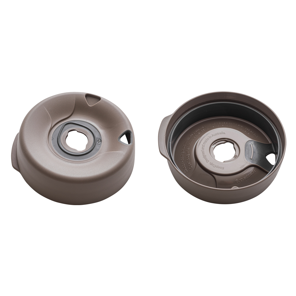 Splashproof Lid Base for KeepCup Brew XS in Silver Brown, shown from two angles: the domed top view displaying the central drinking hole and side ventilation slots, and the underside revealing the internal mechanism and "Designed and made in Australia" text moulded into the plastic.