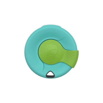 Top-down view of a KeepCup Splashproof Lid in turquoise with a lime green sliding closure featuring the embossed KeepCup logo, shown against a white background.