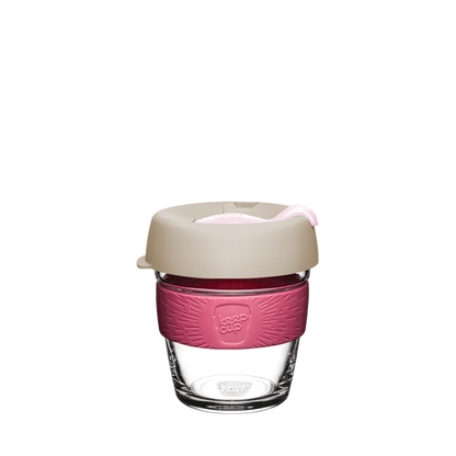 KeepCup Brew XS 6oz in Primrose, featuring a clear glass cup with a guavaband and latte lid with pink plug, shown against a plain white background.