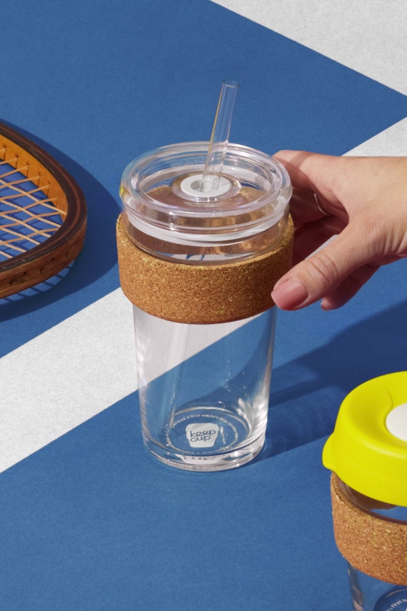 Woman holding KeepCup Cold Cup Cork Ace 16oz on tennis court