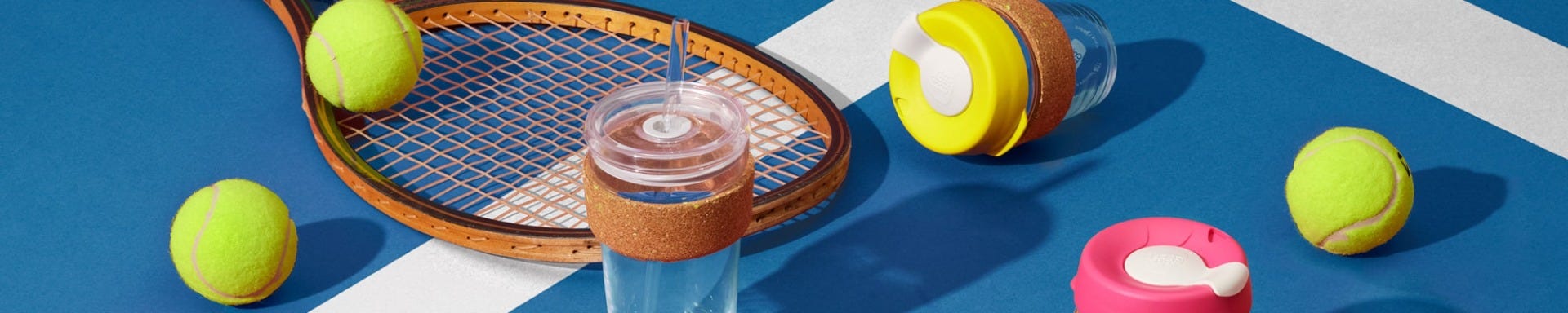 KeepCup Ace Cold Cup Cork and Brew Cork against tennis court with tennis balls and racquet